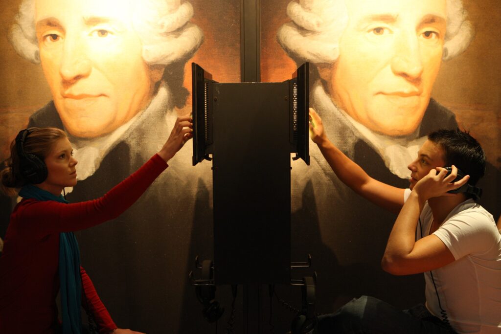 Two visitors listen to pieces and information about the composer Joseph Haydn